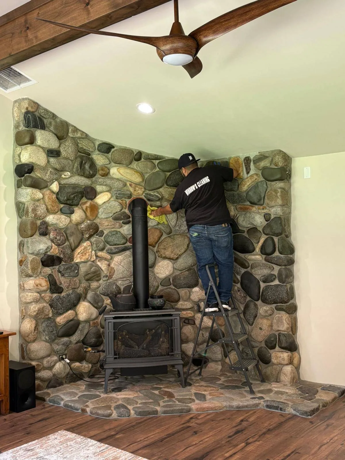 Cleaning a river-rock fireplace in a Methow home
