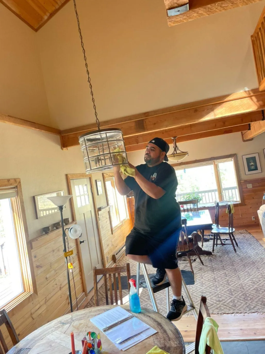 Cleaning the pendant light in a log cabin home